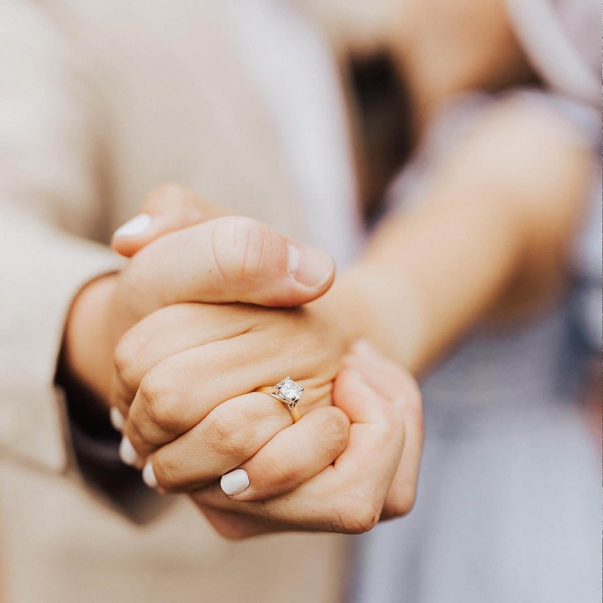 A couple holding hands after a proposal