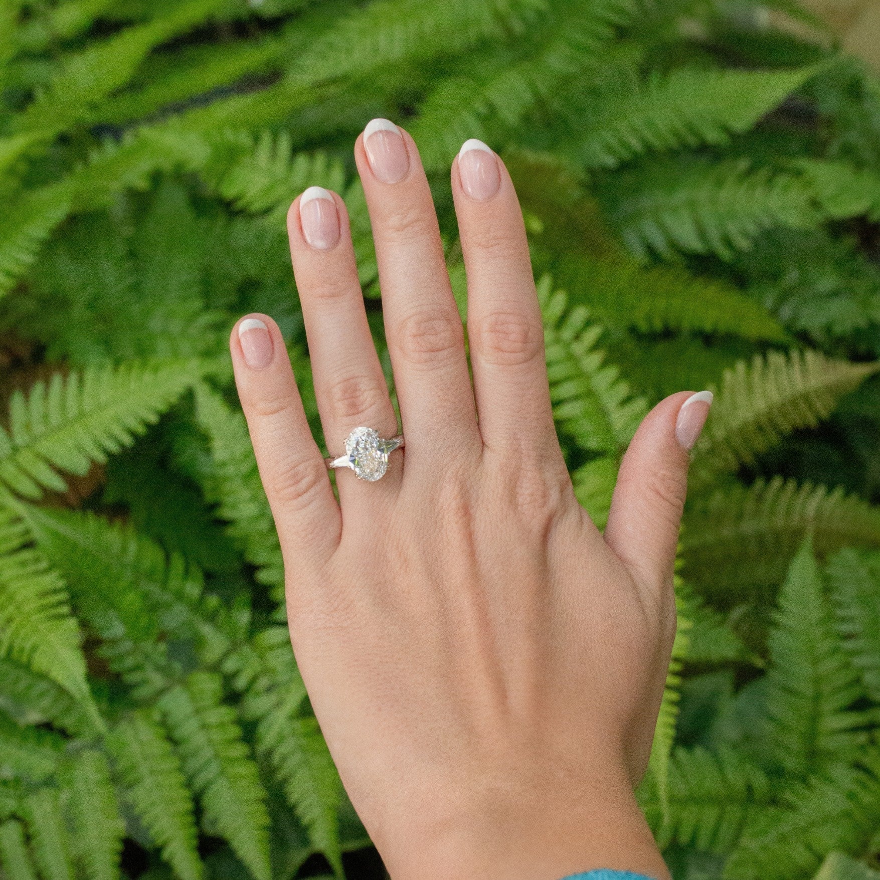 woman wearing diamond ring with trees in background