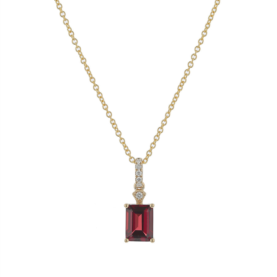 Gold necklace with a red gemstone pendant on a white background