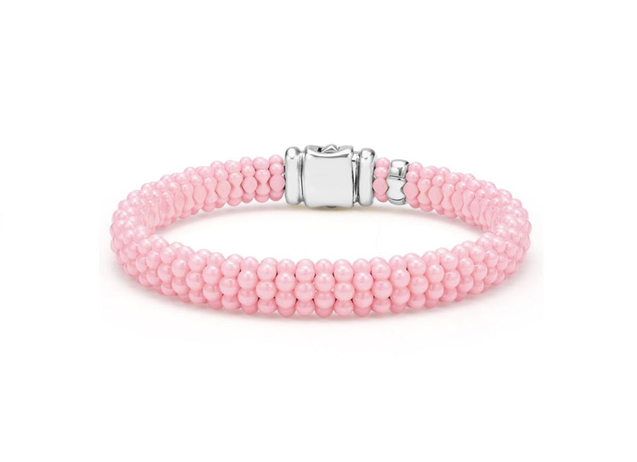 A pink ceramic bracelet with sterling silver accents and a silver clasp, viewed from a angled perspective against a white background.