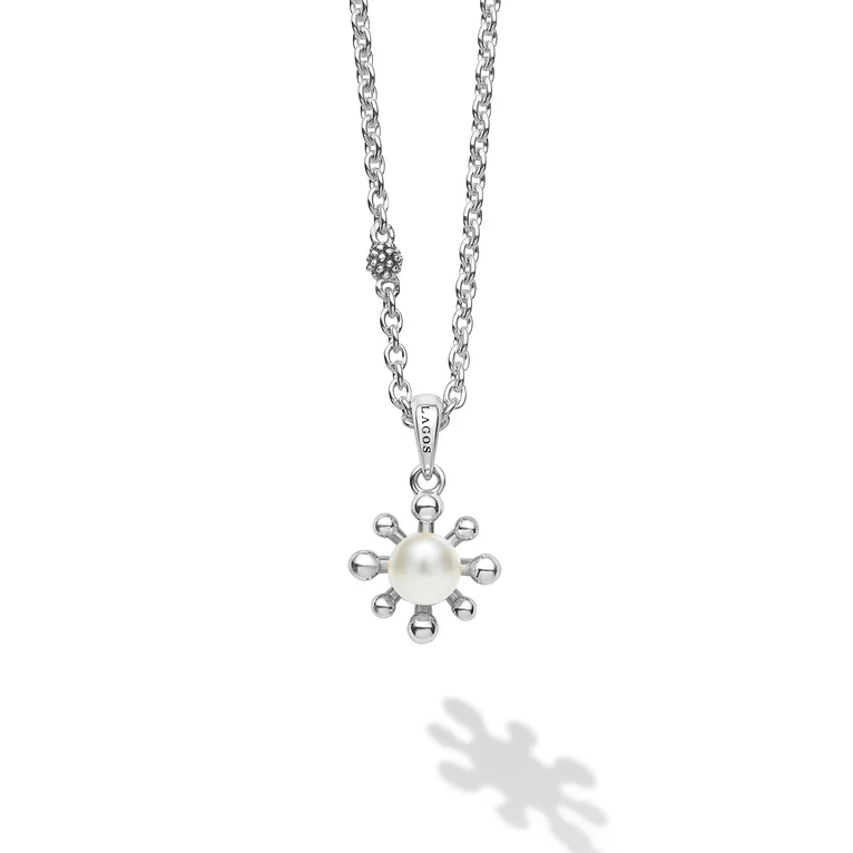 Silver necklace with a pendant featuring a pearl on a white background