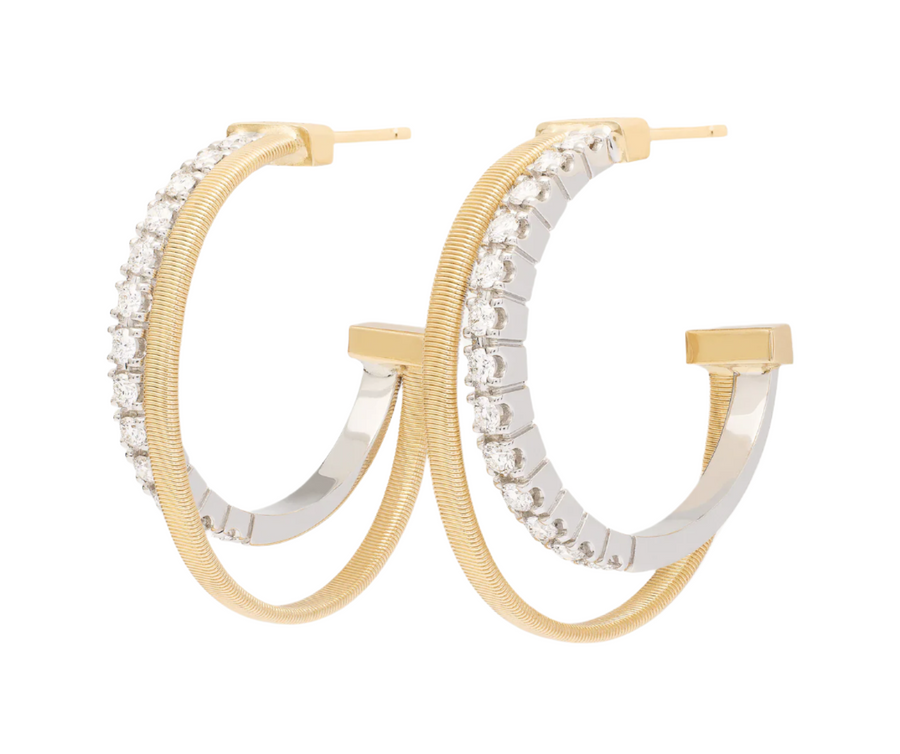 Gold and silver hoop earrings on a white background