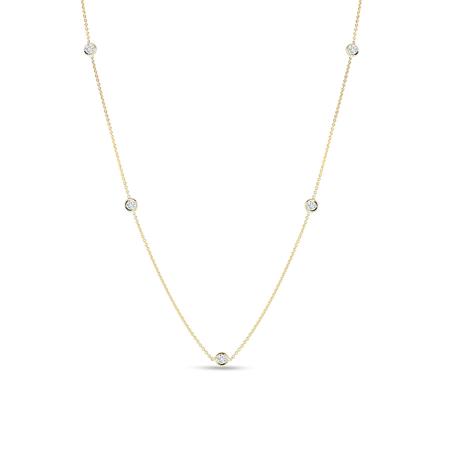 A 18K yellow gold necklace with adjustable stations featuring round diamonds.