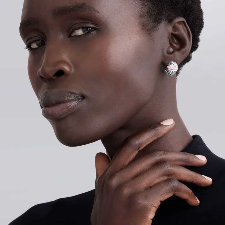 Close-up of a woman wearing earrings with a neutral background