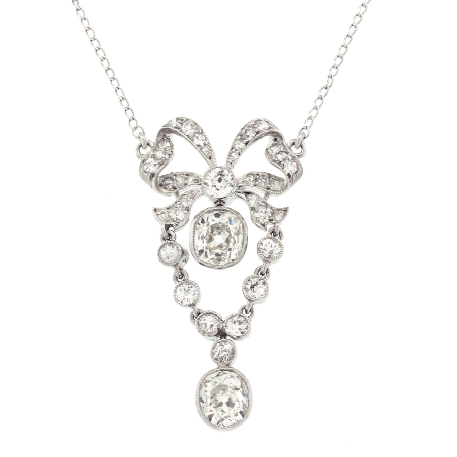 14KW 2 OMC DIAS=1.25CT H-I/SI2 8 OEC DIAS=0.31CT AND 26 SINGLE CUT DIAS=0.25CT BOW PEND ON 16" CHAIN