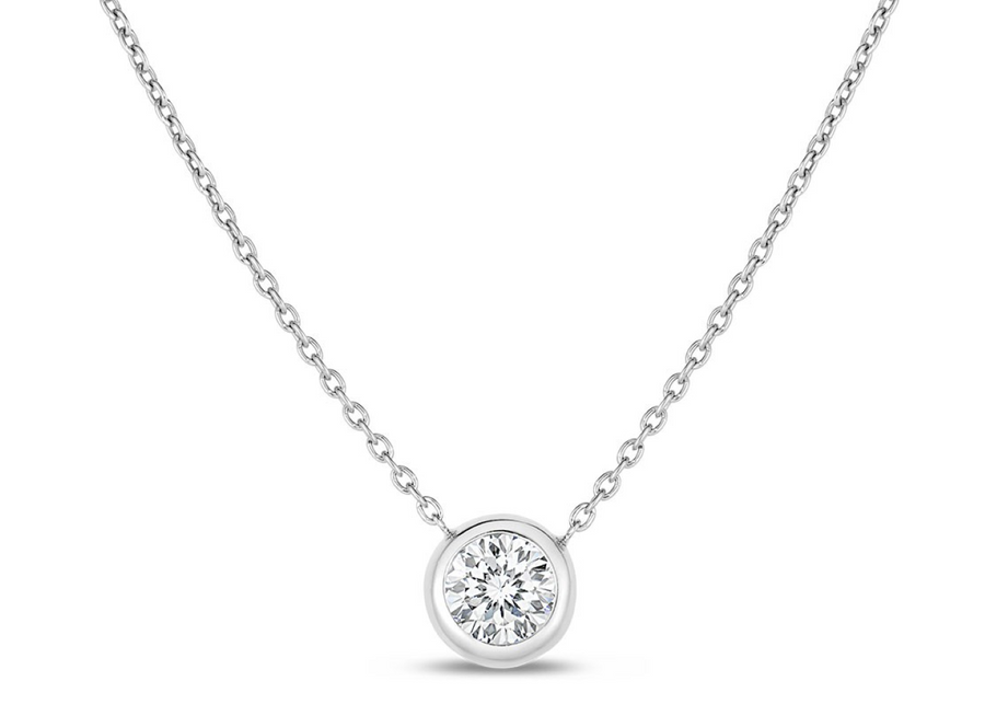 A 0.19ct round diamond bezel set in a 18K white gold necklace on a 20-inch chain.