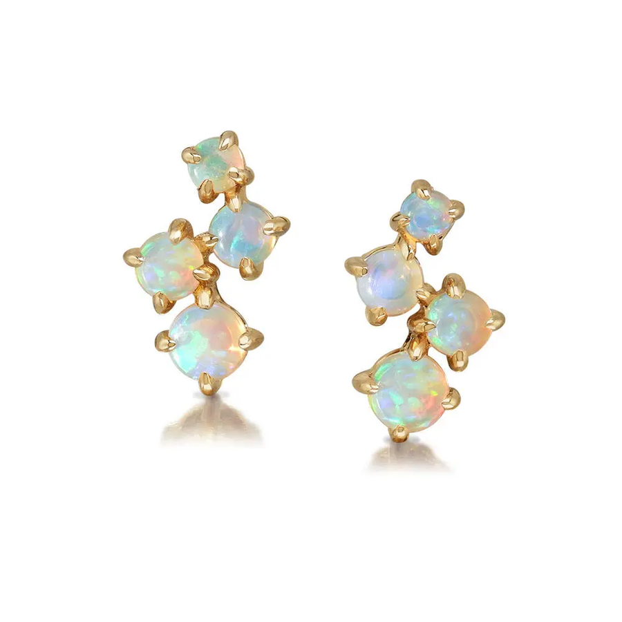 Gold earrings with opal stones on a white background