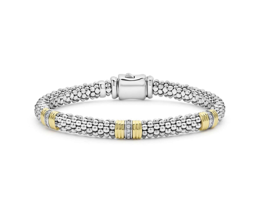 A luxurious Signature Caviar bracelet with a three-fluted station design featuring diamonds, crafted in sterling silver and 18K yellow gold.