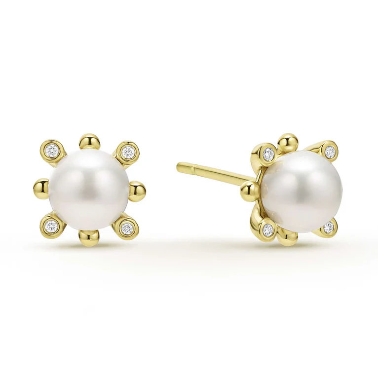 Pearl earrings with gold accents and small diamonds on a white background