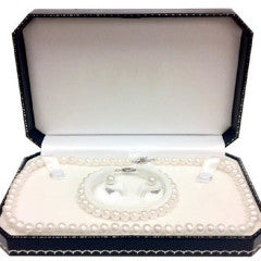 Open jewelry box with a pearl necklace, bracelet, and earrings inside