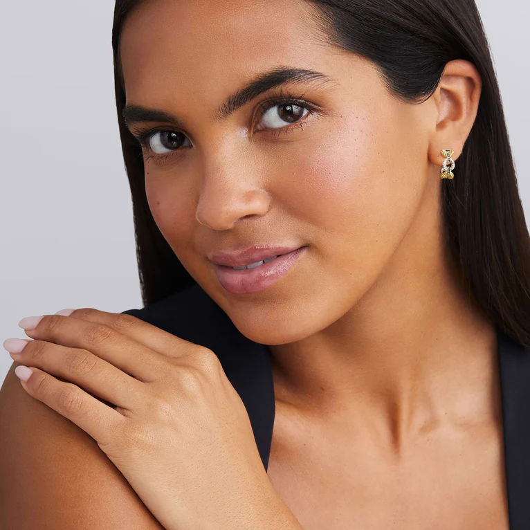 Woman wearing a black top with a plain background