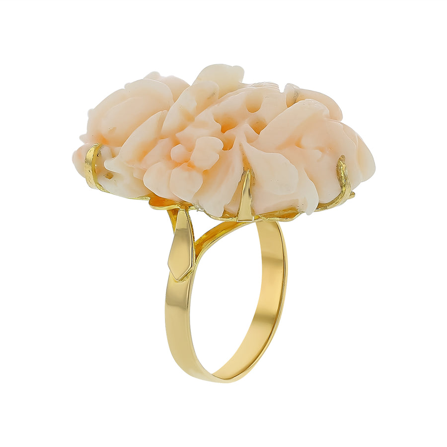 Ring with floral design and gold band on a white background