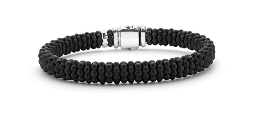 A black caviar beaded rope bracelet with silver and gold color accents.