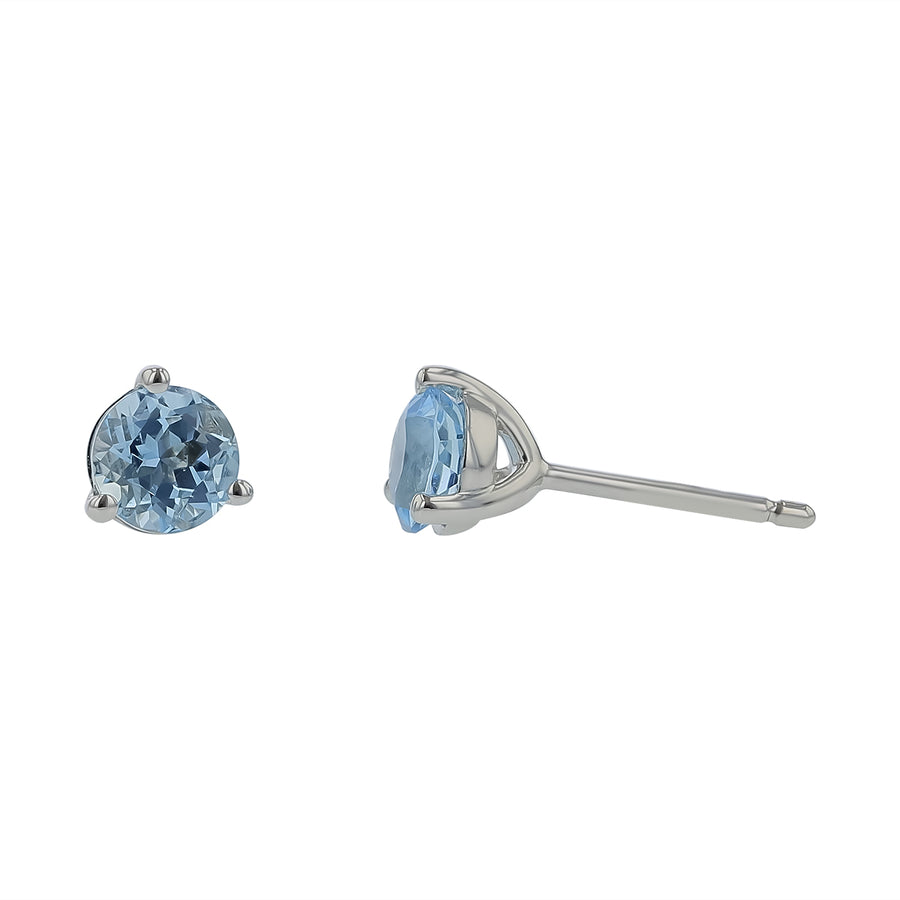 A pair of martini 3-prong stud earrings with heated aquamarine stones set in 14K white gold.