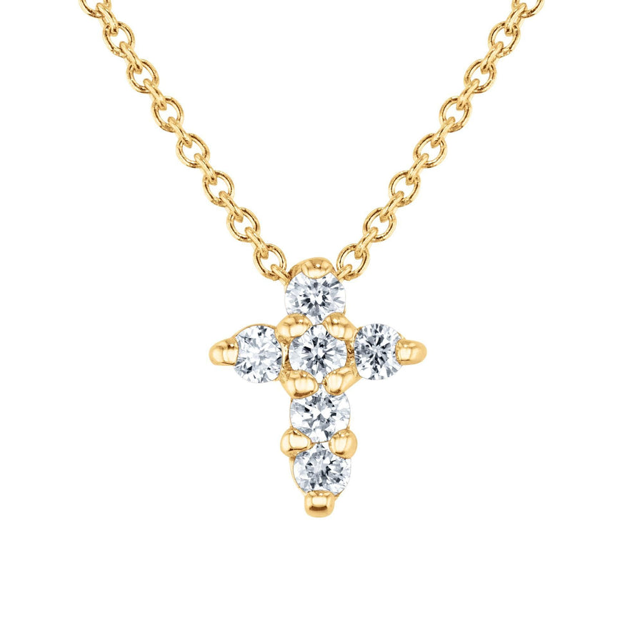 A 18K yellow gold baby cross pendant with diamonds, accompanied by an 18-inch chain.