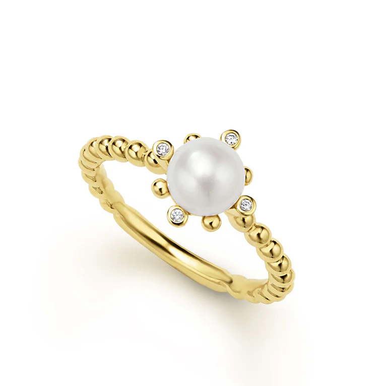 Gold ring with a pearl and small diamonds on a white background