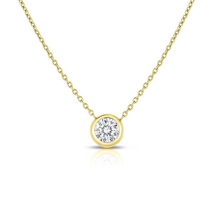 A 0.19ct round diamond bezel set in a 18k yellow gold solitaire pendant necklace with a chain.