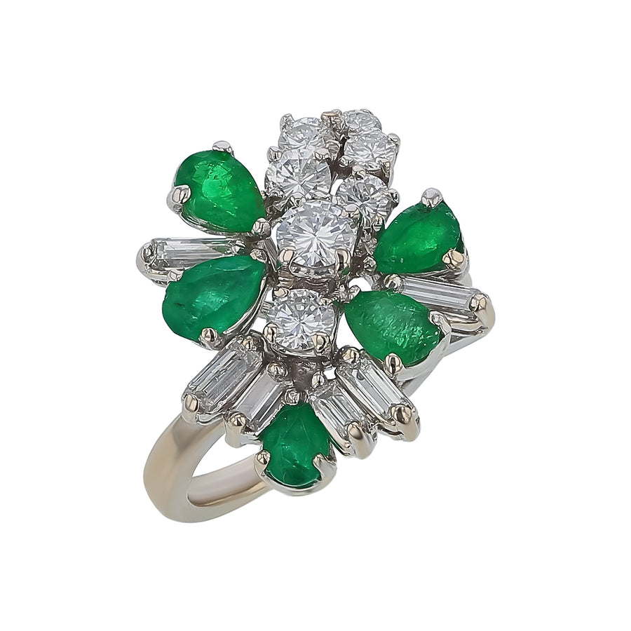 Elegant ring with emeralds and diamonds on a white background