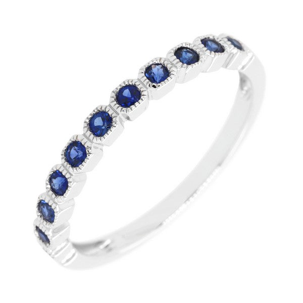 Silver ring with blue gemstones on a white background